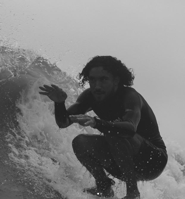 Surfer showing pure stoke on a clean wave